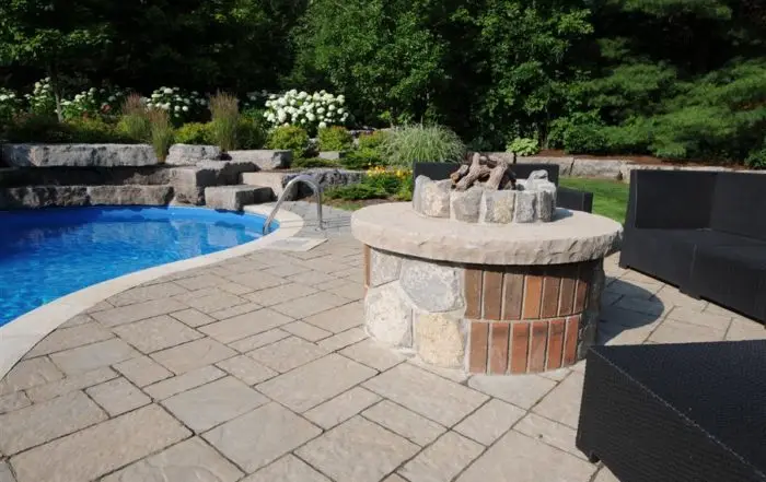 Poolscape with outdoor fireplace